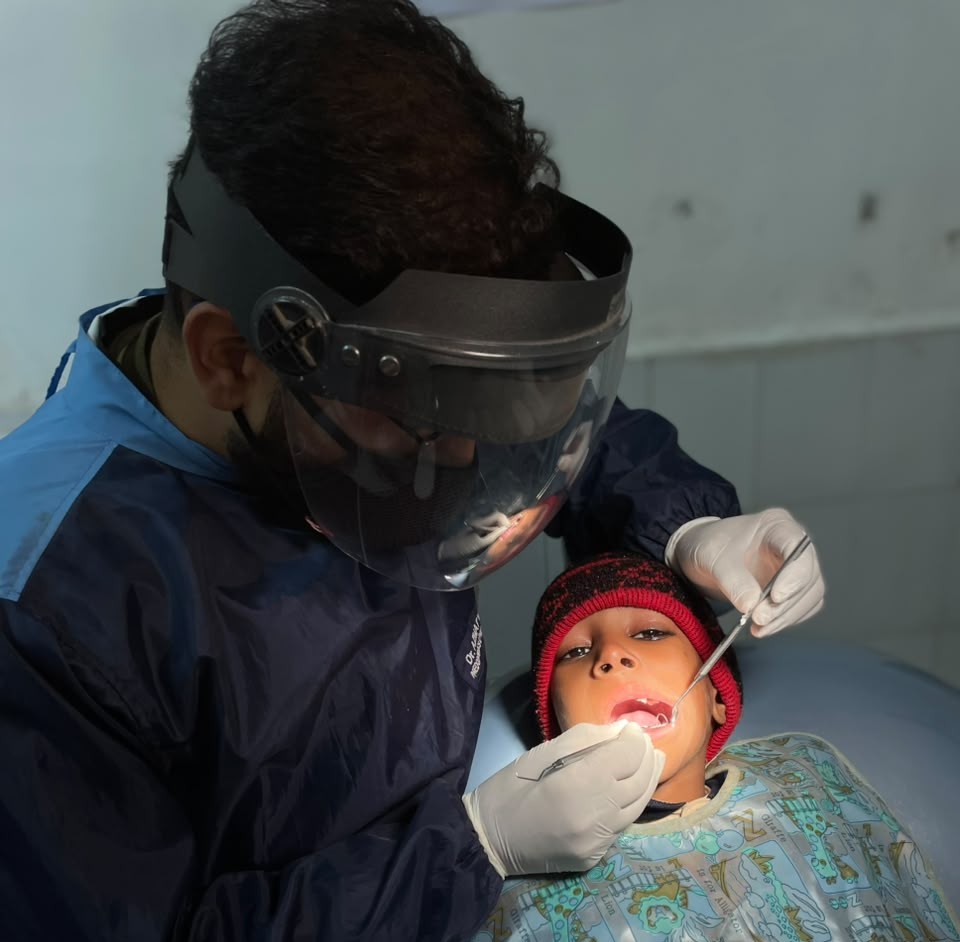 Dr. Faizan treating a young patient